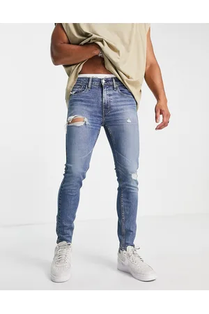 Levi's 519 super skinny jeans in mid wash with distressing