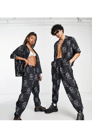 COLLUSION Unisex co-ord noughties fit joggers with all over print in