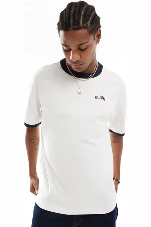 Hollister Cremehvid/marineblå ringer-t-shirt med collegelogo og firkantet pasform i kraftigt stof