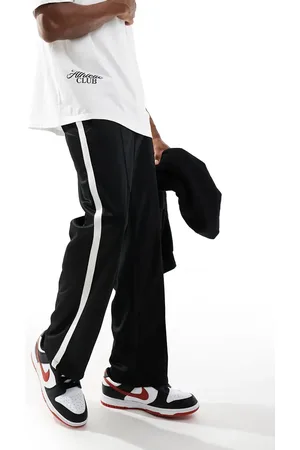 Bershka Sorte joggingbukser med sidestriber i bred pasform