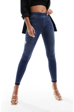 Spanx Formende, løftende skinny-jeans med sliddetaljer i mellemvasket blå