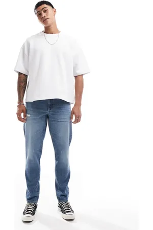 ASOS Tapered jeans med sliddetaljer i blå mellemvask