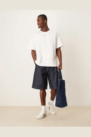 ASOS Mørkeblå og forvaskede lange jorts i denim med plisseringer