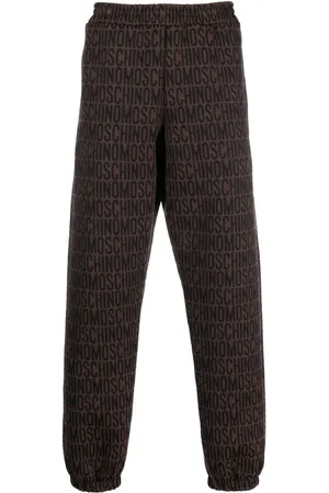Moschino All-over embroidered logo track pants
