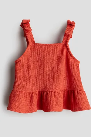 H&M Rusettikoristeinen peplum-toppi